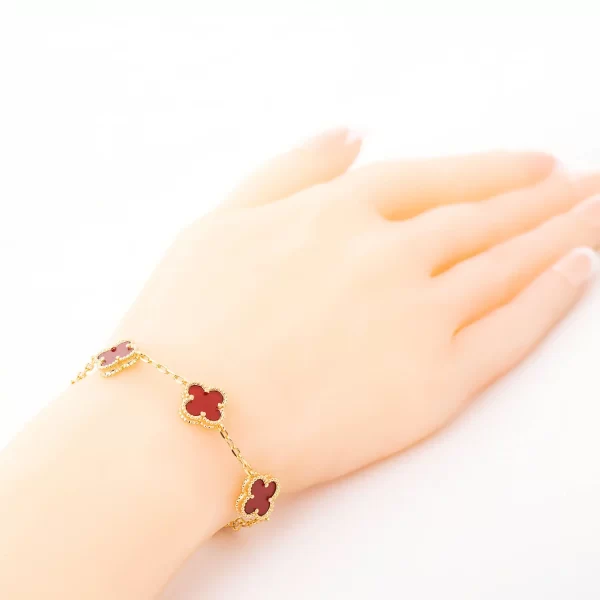 Golden bracelet five roses with maroon stones