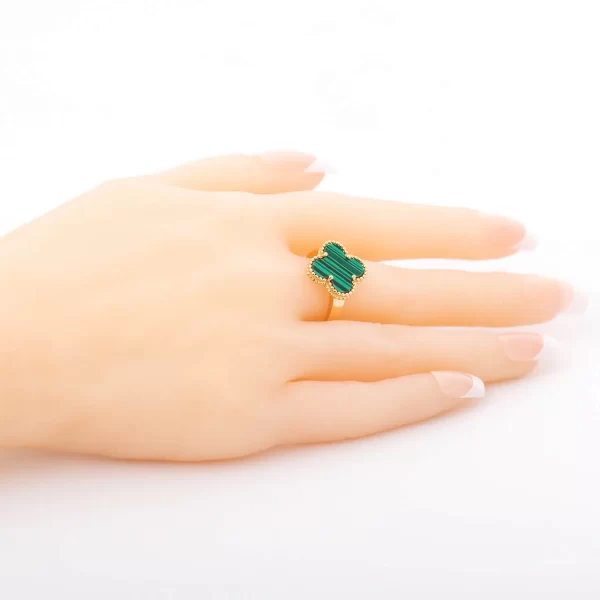 Golden plated ring with green stone